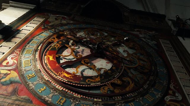 Historic astronomical clock inside St Paulus Dom in M&uuml;nster, Germany. Decorative medieval timepiece with zodiac symbols, ornate artwork and detailed cathedral interior craftsmanship.