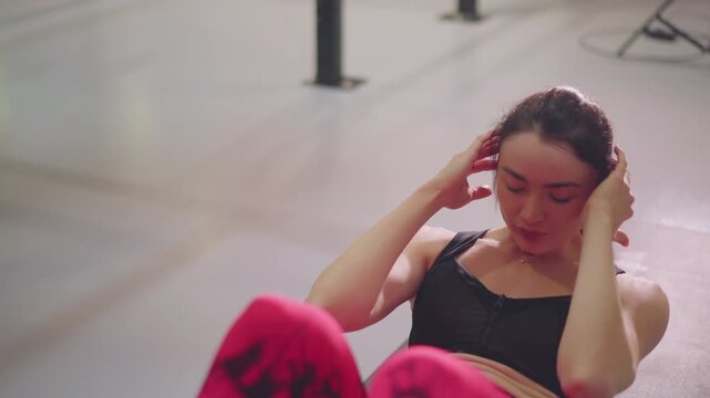 Focused athlete finishing core session on mat with hands at temples, slow breath and guided cooldown, mindful posture, soft studio lighting and wellness coach vibe promoting postworkout relaxation