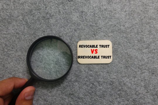 Magnifying glass examines revocable vs irrevocable trust comparison