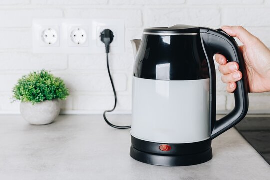 Modern Electric Kettle on a Kitchen Counter with a Minimalist Design and Indoor Plant