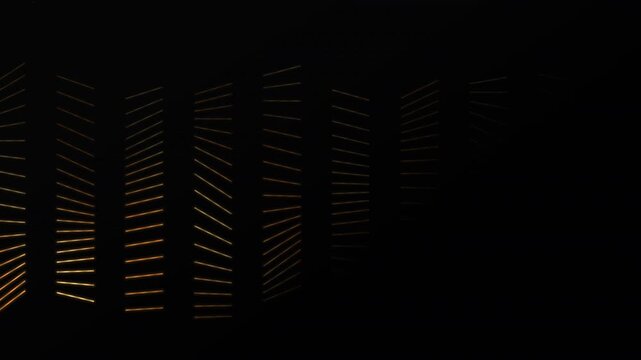 Gold and orange lines weave mesh pattern across black gradient backdrop