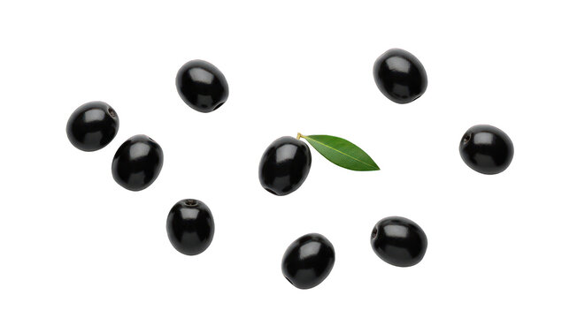 Top view of nine glistening black olives scattered around a green leaf