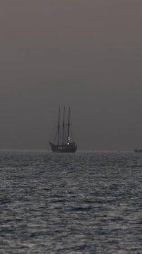 Vintage three-masted schooner sailing on calm ocean