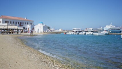 Fototapeta premium Coastal harbor with whitewashed buildings and boats softly blurred bokeh background outdoor; backdrop copyspace backplate.