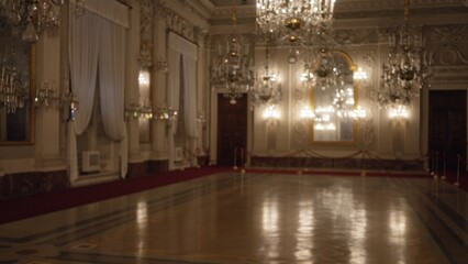 Opulent palace ballroom with crystal chandeliers, heavy drapes and polished parquet, defocused and softly blurred interior  background backdrop copyspace calm. © Krakenimages.com