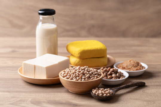 Assorted soy products: Tofu, soy milk, miso paste and natto on wooden background