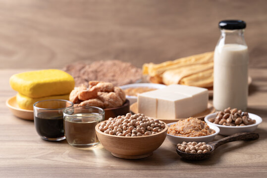 Assorted soy products: Tofu, soy milk, miso, natto, soy sauce, soybean oil, TVP, yuba and fermented soybean paste on wooden background