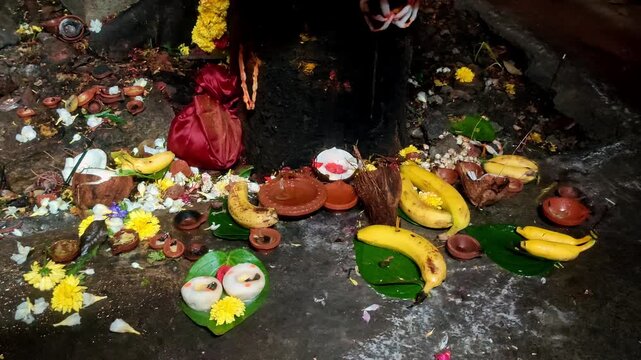 Closeup of Traditional Hindu Temple Ritual with Bananas Coconuts Flowers and Sacred Diya Offering