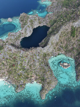 Aerial view of the tranquil Kayangan Lake nestled amidst jagged limestone cliffs and vibrant turquoise waters, Coron, Mimaropa, Philippines.