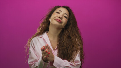 Naklejka premium Woman face and hands shrugging with palms up in pink studio wearing light shirt and long curly hair; indifference gesture.
