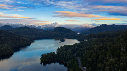 Fototapeta premium Panoramic aerial view of lakes and snow-capped Andes mountains along the scenic Seven Lakes Route in Patagonia, Argentina.