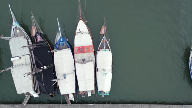 Top-down View Of Traditional Boats Docked At A Marina In Paraty, Brazil. - aerial shot