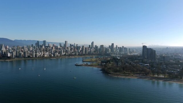 Downtown Vancouver Seen From English Bay With Tranquil Water In BC, Canada. - aerial shot
