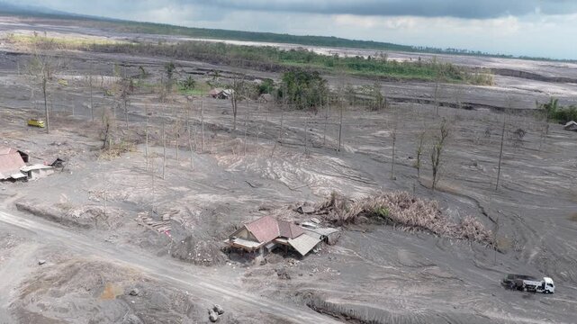 Aerial view of a village destroyed by volcanic ash and lahar mudflows from the semeru volcano eruption. Destroyed homes and a barren landscape