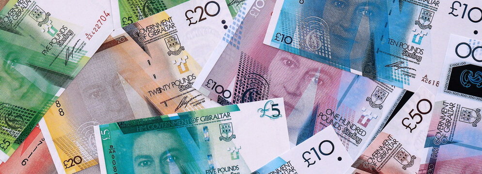 Gibraltar pound money bills pile on table. Gibraltar banknotes of GIP currency close up.