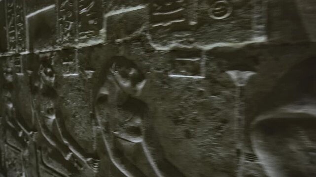 Dendera temple underground crypt corridors with hieroglyphic reliefs on walls in Egypt, narrow ancient passageways with carved inscriptions.