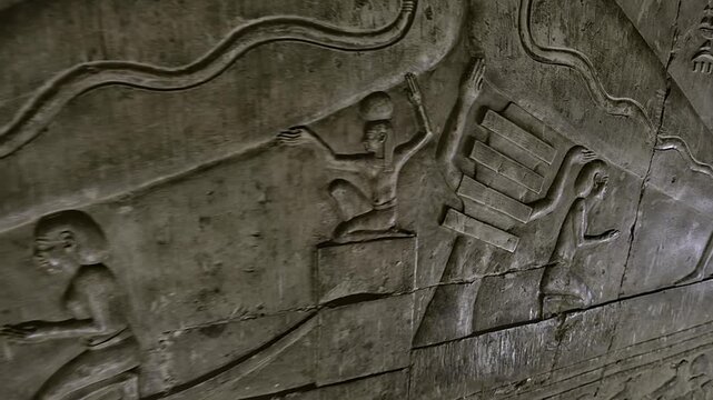 Dendera temple underground crypt corridors with hieroglyphic reliefs on walls in Egypt, narrow ancient passageways with carved inscriptions.