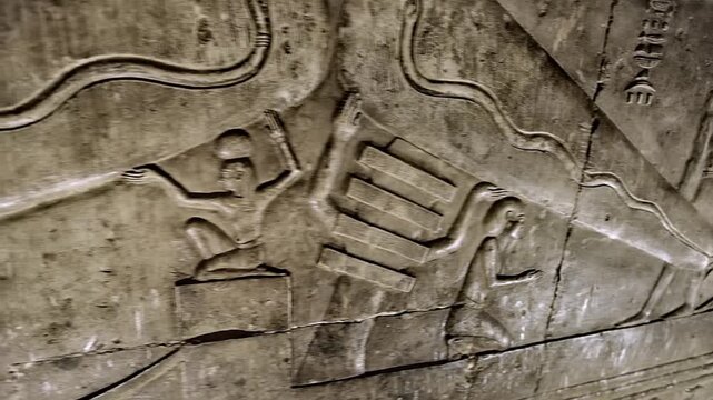 Dendera temple underground crypt corridors with hieroglyphic reliefs on walls in Egypt, narrow ancient passageways with carved inscriptions.