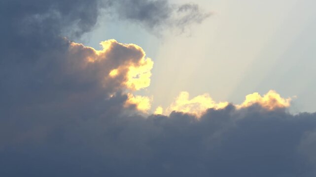 Telephoto Close-up of Sun Hiding Behind Dark Cumulus Clouds