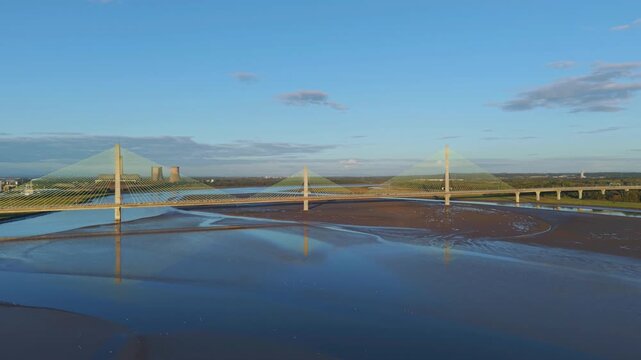 Liverpool, Merseyside, UK, June 19, 2025; Aerial 4K video footage of the Mersey Gateway toll bridge with stunning views over the River Mersey, Liverpool, UK.