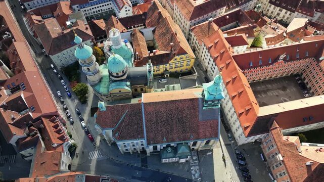 Aerial view of the Mausoleum of Graz, with its distinctive green domes contrasting against the red-tiled rooftops, Graz, Styria, Austria.