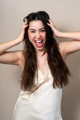 Fototapeta premium Young woman showing excitement in lace camisole