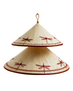 A stack of conical hats with dragonfly details against a black background