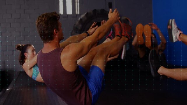 Man leading fitness class on cue performing V-up pulses on mats, ECG overlay indicating core effort