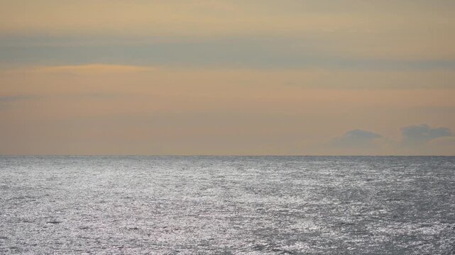Golden hour sunlight reflecting on calm seascape
