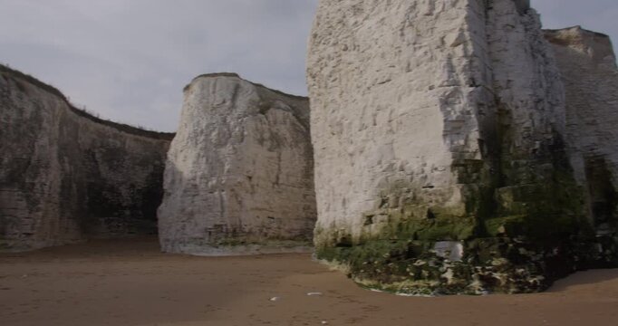 Extra wide panning up shot of the chalk stacks and cliffs at Botany Bay Beach at low tide. At marine Drive, Broadstairs