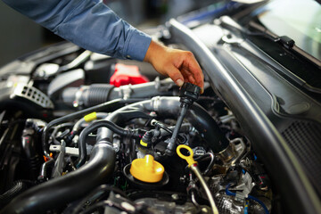 Mechanic auto shop diesel engine sensors injectors common rail check maintenance engine bay automotive service professional technician