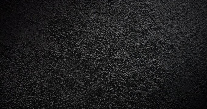 Black Rough Texture Background. A slow panning footage across a deep black grainy surface revealing tactile depth through gentle shadow shifts 