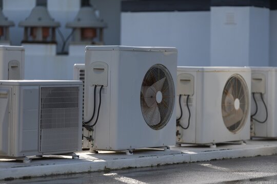 HVAC systems operate on a rooftop with industrial air conditioning units providing ventilation and cooling for commercial buildings and urban infrastructure.