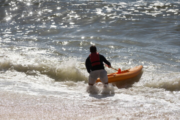  a kayak in the blue sea man kayaking he does water sports activities.