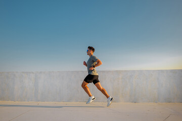 Runner practices on rooftop during sunset, enjoying outdoor workout for fitness and health