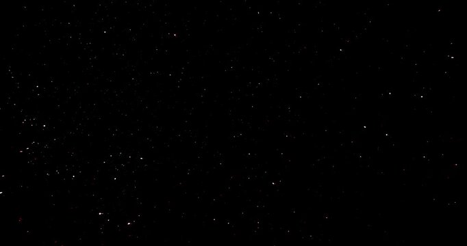 Fast flickering shining dots abstract background.  Twinkling  micro-glitter particles gently floating and sparkling against black background.