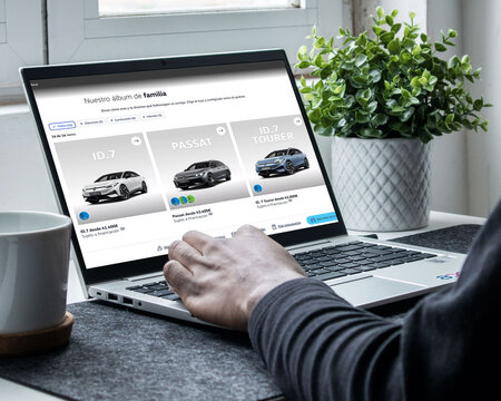 Person browsing new car models online using laptop