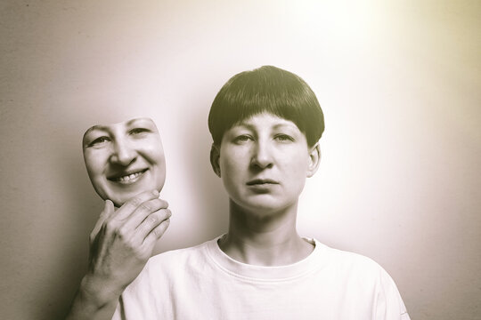 The woman hides her true emotions behind a happy mask.