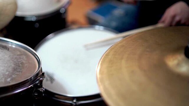 Musician with cymbal and music instrument hobby Beautiful Young Drummer Playing at a Band Rehearsal Among the items on the drum kit is a tambourine