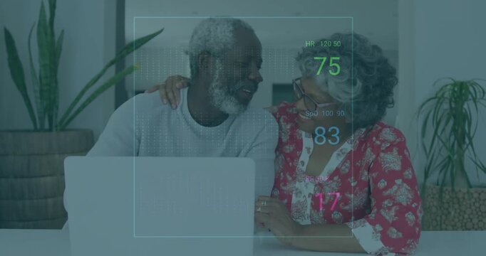 Senior woman and man sharing moment in living room, viewing animated heart rate and oxygen graphics