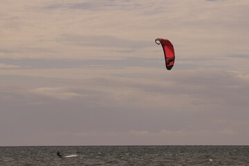 에메랄드빛 바다 위에서 시원하게 바람을 가르며 카이트 서핑을 즐기는 역동적인 해양 스포츠 풍경
