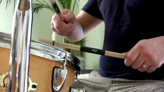 Musician with cymbal and music instrument hobby Beautiful Young Drummer Playing at a Band Rehearsal Among the items on the drum kit is a tambourine