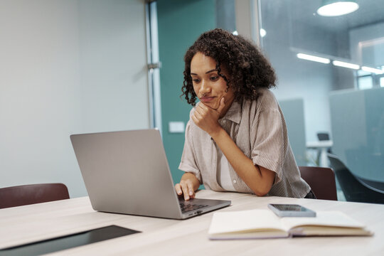 Woman Examining Data Carefully. Female Professional Deeply Analyzing Data For Report Preparation