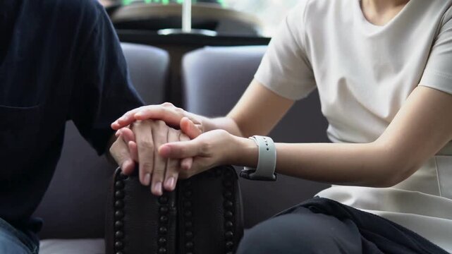 elderly man and woman holding hands together for unity, respect and compassion. unrecognizable romantic couple holding hands. concept of trust and love.