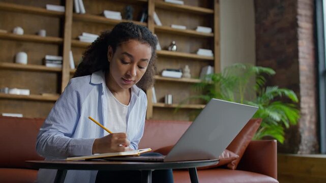 Woman Taking Notes During Online Lesson