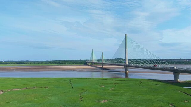 Liverpool, Merseyside, UK, June 19, 2025; Aerial 4K video footage of the Mersey Gateway toll bridge with stunning views over the River Mersey, Liverpool, UK.