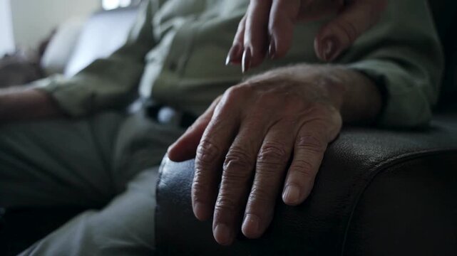 Senior woman putting her hand on her husbands while sharing moments of bonding. Affectionate elderly married couple having bonding moments together.