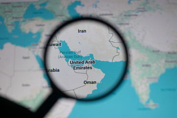 Close up of map showing Strait of Hormuz and Persian Gulf region under magnifying glass, highlighting geopolitical tensions, oil supply routes, and strategic location between Iran, Oman and UAE waters © Sreeyash