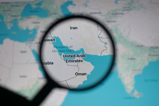 Close up of map showing Strait of Hormuz and Persian Gulf region under magnifying glass, highlighting geopolitical tensions, oil supply routes, and strategic location between Iran, Oman and UAE waters