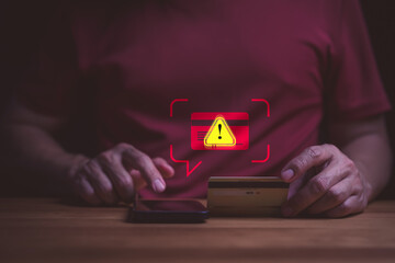 Credit card fraud alert and cyber security concept. User on smartphone with online payment scam warning. Phishing, identity theft, hacked banking account, and data protection risk. © ParinPIX